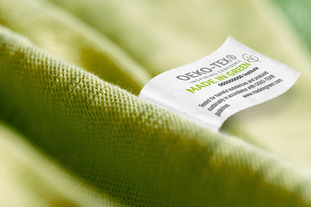 green fabric with MADE IN GREEN by OEKO-TEX label