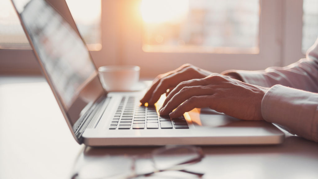 closeup of hands at laptop