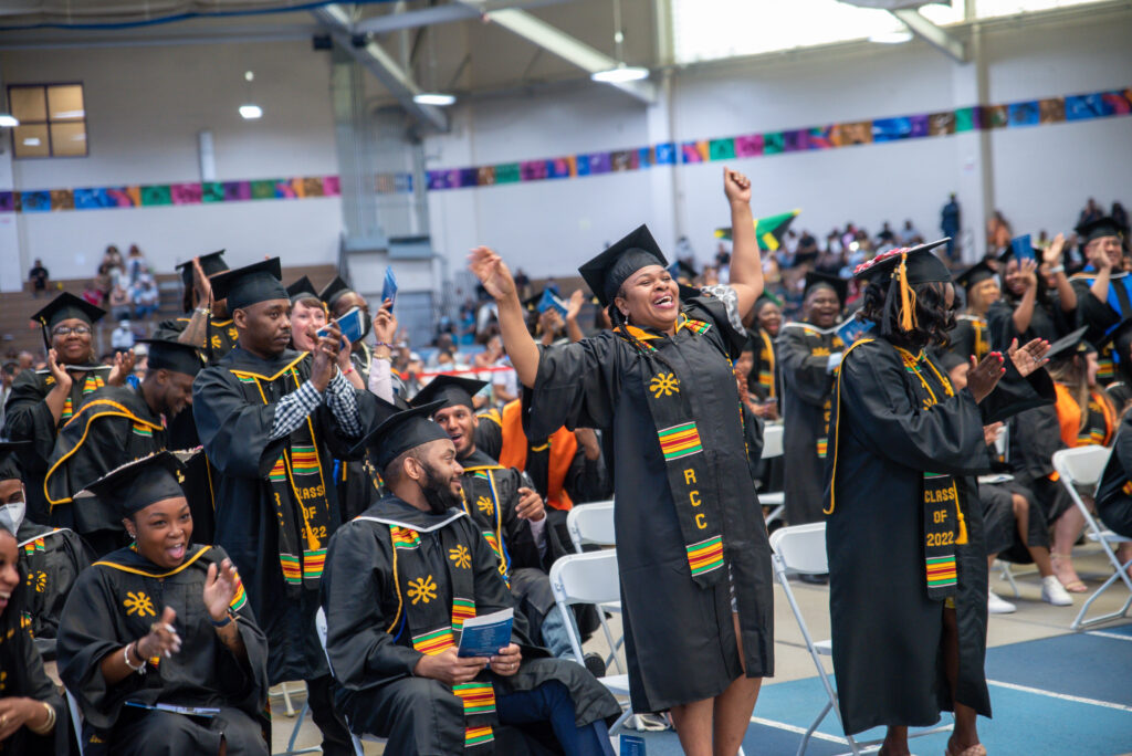 Students reacting to receiving a gift of $1000 from the keynote speaker at Roxbury Community College's 2022 graduation.